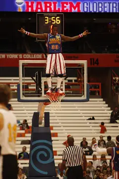 Bull stands on the rim with his arms extended. Moments later, after a 6-point attempt by Global, Bull kicks the ball away, resulting in a goaltending call and six points for the opposition. 