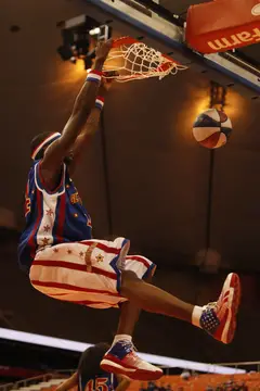6-foot-8 Bones goes up for a ferocious dunk off after a string of crafty passes by the Globetrotters.