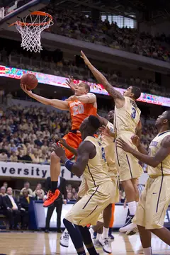 Syracuse guard Brandon Triche rises above the Pitt defenders for a fast-break layup at the Petersen Events Center on Saturday. Pitt defeated the Orange 65-55 in the Big East matchup. Triche finished with 14 points on 4-14 shooting. 