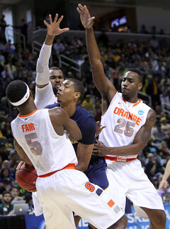 California's Richard Solomon loses his handle on the ball as he is swarmed in the paint by C.J. Fair, James Southerland and Rakeem Christmas.