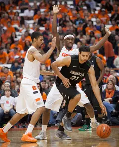 Gbinije (left) and Fair (back right) defend the Bearcats' Nick Madray. 