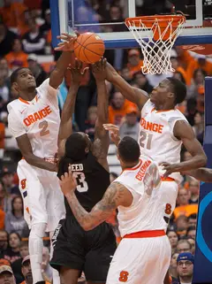 From left to right: Syracuse's B.J. Johnson, Coleman and Tyler Roberson block Reed in the paint. 