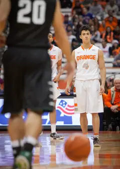 Syracuse senior guard Nolan Hart, who saw rare action on Saturday, looks down the court, ready to defend.