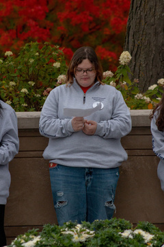 Remembrance Scholar Riley Moore looks over the list of Pan Am Flight 103 bombing victims whose names she is preparing to read aloud to the gathered crowd. Moore represented one of the 35 Syracuse students that was killed in the terrorist attack. 