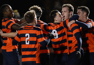 Jordan Vale (2), Stefanos Stamoulacatos (9) and Lars Muller celebrate their 1-0 victory over Cornell on Thursday. The Orange advances to the second round of the NCAA tournament to take on No. 14 VCU in Richmond, Va.