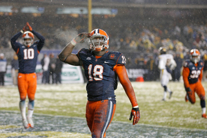 Siriki Diabate salutes the crowd to celebrate after combining to sack West Virginia quarterback Geno Smith for a safety to put Syracuse up 5-0 in the first half of the Pinstripe Bowl.