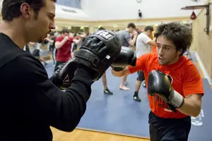 
(Left) Joe Stray and Luke Harrigan, boxing coach and sophomore international relations major, respectively, practice in Archibold Gymnasium as part of the reestablished boxing club.