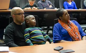 Quentin Hillsman (left) sits with his son, Kyan, at the NCAA tournament selection show. The Syracuse head coach has been staying up late at night watching film of Chattanooga, his team's first-round matchup. 