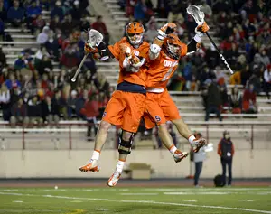 Randy Staats (left) and Kevin Rice (right) celebrate in Syracuse's 14-9 win over Cornell on Tuesday night. 