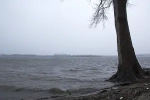 Small waves settle on Onondaga Lake’s shore beneath a cloudy sky. Onondaga County and Honeywell plan to continue their cleanup of the lake, which was once one of the most polluted in the United States. Onondaga County has funded roughly $500 million of the $1 billion cleanup project.
