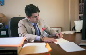 Boris Gresely, Student Association president, writes a to-do list in his office. 