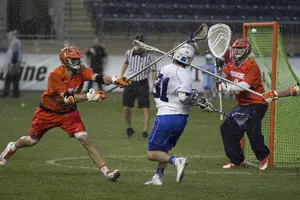 Duke's Jordan Wolf finishes a shot over Bobby Wardwell last Friday in the ACC semifinals. The Orange's defensive breakdowns led to 30 goals allowed in the ACC tournament.