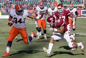 Adonis Ameen-Moore avoids a defender on the way to an 18-yard touchdown run against Temple in 2012. Syracuse's coaches hope Ameen-Moore can provide the physical, downhill running that Jerome Smith brought last year.