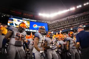 Syracuse players get ready to storm onto the field in their new gray uniforms before a loss to Notre Dame on Saturday night. 