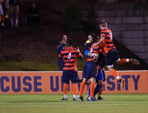 Syracuse celebrates in front of its goal after beating No. 2 Virginia 1-0 at SU Soccer Stadium on Saturday night. 