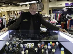John Michael shows off the wide selection of watches at his store, J Michael Shoes, on Marshall Street. Michael opened the store more than 30 years ago.                               