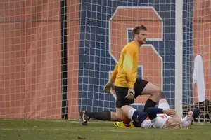 SU forward Emil Ekblom reacts while lying on the ground in front of Penn State goalie Andrew Wolverton, who made eight saves and kept the Nittany Lions in the game.
