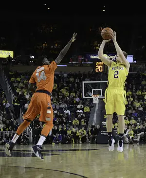 Michigan guard Spike Albrecht hit a trio of 3-pointers in the second half as the Wolverines outshot the Orange's zone and came away with a 68-65 win Tuesday night.