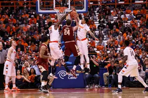 Chinonso Obokoh (left) and Michael Gbinije (right) defend against a Dennis Clifford layup in the second half. The SU bigs limited BC's effectiveness down low even with Rakeem Christmas sidelined due to foul trouble.