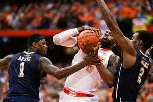 Rakeem Christmas struggles to evade a double team of Pitt's Michael Young and Jamel Artis. SU was unable to complete its comeback on Saturday, falling to the Panthers by four.