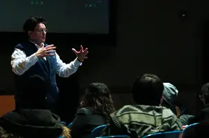 Marc Lapadula, an award-winning screenwriter, playwright and producer, speaks animatedly to a group of students and members of the public alike during his seminar at Syracuse Studios.     