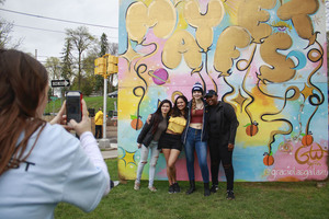 (From left to right) June Huynh, Shriya Rawal, Kelsie Wilson and Alicia Harris pose in front of the 2019 Mayfest wall during the event organized by University Union.