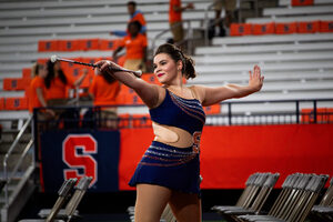The role of SU Orange girl has a long, storied history. Abigail Veccia is the latest twirler for the marching band and keeps in touch with the women who previously held her position.
