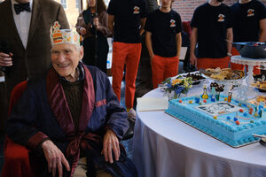 Marvin Druger spends his 90th birthday in the atrium of the Heroy Geology Building at Syracuse University. His friends and family came to watch the festivities, live music, grand speeches and the cake cutting featuring Druger's face.
