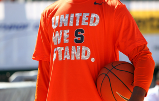 A Syracuse Orange player is seen with a United We Stand shirt prior to the game against the San Diego State Aztecs during the Battle on the Midway on Sunday aboard the USS Midway Museum.