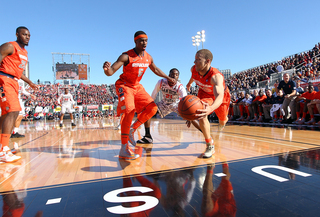 Brandon Triche #20 of the Syracuse Orange reaches to keep the ball in bounds with teamate C.J. Fair against Jamaal Franklin of the San Diego State Aztecs during the Battle on the Midway game on Sunday.