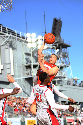 Brandon Triche of the Syracuse Orange puts the ball up to the basket against Jamaal Franklin of the San Diego State Aztecs during the Battle on the Midway game on Sunday.