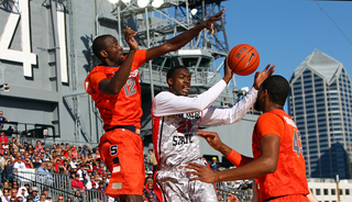 Baye Moussa Keita and James Southerland of the Syracuse Orange reach for the ball against Jamaal Franklin of the San Diego State Aztecs during the Battle on the Midway game on Sunday.