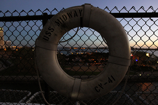 A life ring is seen on the fence of the USS Midway Museum at sunset after the Battle on the Midway basketball game between the Syracuse Orange and the San Diego State Aztecs on Sunday.