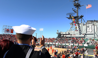 A member of the United States Navy is seen in the stands prior to tipoff at the game between the Syracuse Orange and the San Diego State Aztecs during the Battle on the Midway game on Sunday.