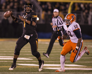 Missouri quarterback James Franklin looks to pass as defensive end Markus Pierce-Brewster chases.