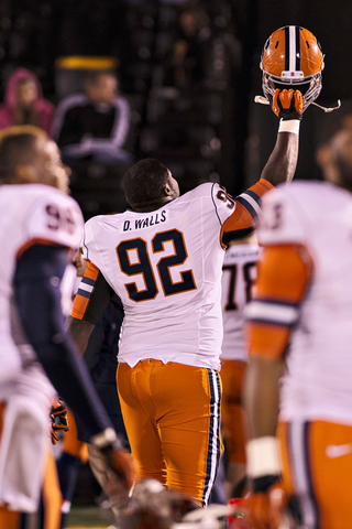 Davon Walls lifts his helmet up in celebration following Syracuse's 31-27 win over Missouri.