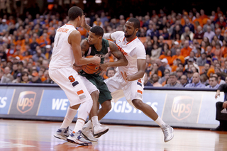 Michael Carter-Williams and James Southerland trap an Eastern Michigan player in Syracuse's victory over the Eagles.