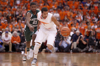 Michael Carter-Williams pushes the ball forward as Syracuse tries to increase the tempo.