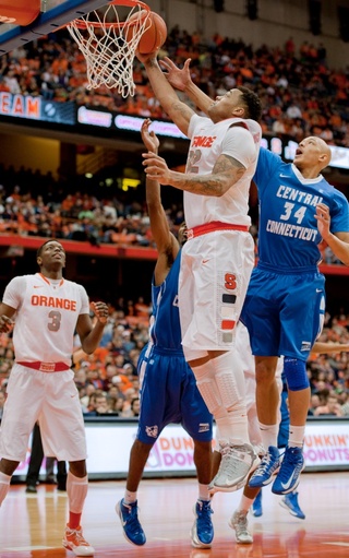 DaJuan Coleman finishes a layup in traffic against a pair of Central Connecticut State defenders.