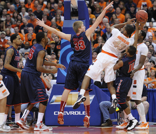 Syracuse forward James Southerland fights for the ball with Detroit's P.J. Boutte.