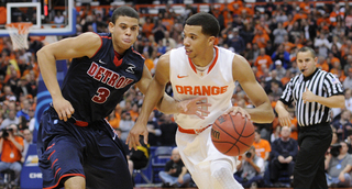 Syracuse guard Michael Carter-Williams looks to break free from Detroit's Ray McCallum.
