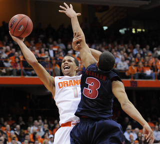 Syracuse guard Michael Carter-Williams attempts a shot while Detroit's Ray McCallum defends. 