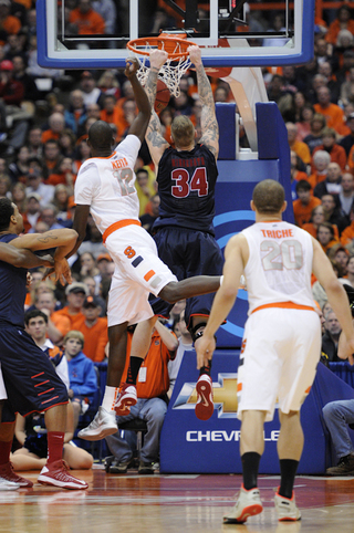 Detroit's Nick Minnerath attempts a dunk as Syracuse center Baye Moussa Keita defends.