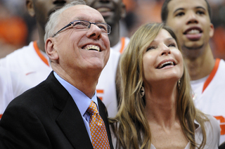 Jim Boeheim and his wife, Juli, smile while they watch a postgame video celebrating the Syracuse head coach's career.