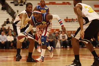 Woody bursts by two Select defenders in the first half of the Globetrotters' 114-100 win Friday at the Carrier Dome. 