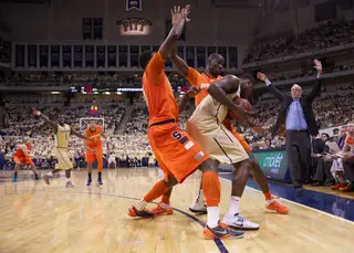 Syracuse forwards Baye Moussa Keita (12) and Jearmi Grant (3) trap Pitt center Dante Taylor as the Orange tried to pressure the Panthers to force a late game turnover at the Petersen Events Center on Saturday. Pitt defeated the Orange 65-55 in the Big East matchup.