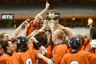 Hobart celebrates its upset of No. 3 Syracuse as its players hoist the Kraus-Simmons Trophy for the first time since 2006.