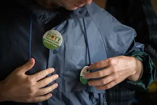 Oct. 19, 2013: Derek Mason, a party member, shows his support by adding pins to his jacket.