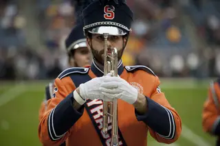 A member of the SU marching band waits to begin a routine.