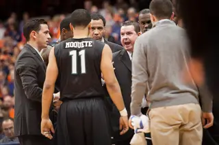 Binghamton head coach Tommy Dempsey directs the Bearcats during a timeout.